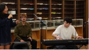 Victor (in white) performing on keyboard during the Melody in the Stacks concert