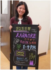 Elene with the karaoke sign for the Dawg Daze event