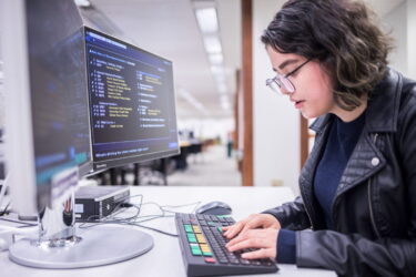 A person using a computer at Foster Business Library