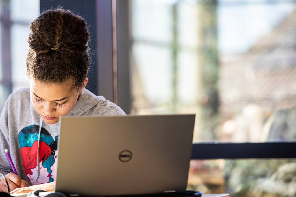 A student working at a laptop