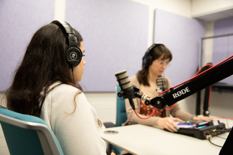 Two students in a soundproof recording studio