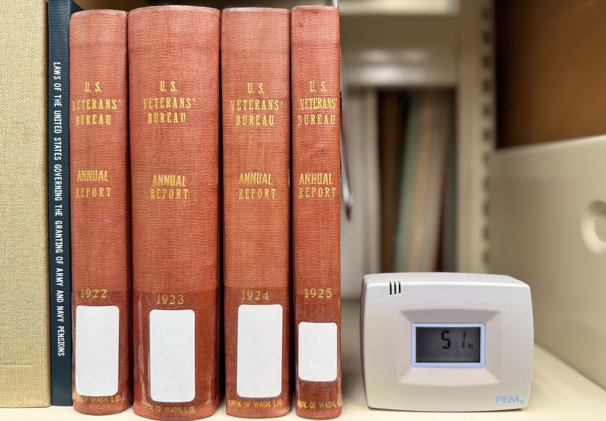 Photo of An image of a datalogger on a bookshelf next to some books