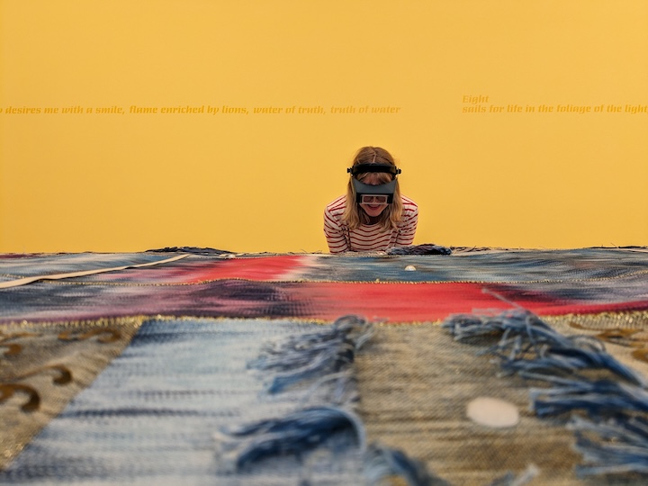 Photo of Textile Conservator Kate Clive-Powell assessing Josh Faught’s Sanctuary prior to exhibition at the Henry Art Gallery in 2025