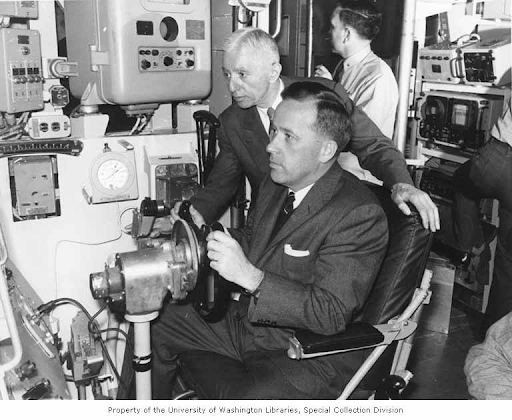 Alt text Photo: Senator Henry M. Jackson sitting at the controls of the nuclear submarine, the USS GEORGE WASHINGTON off the coast of New England, 1960