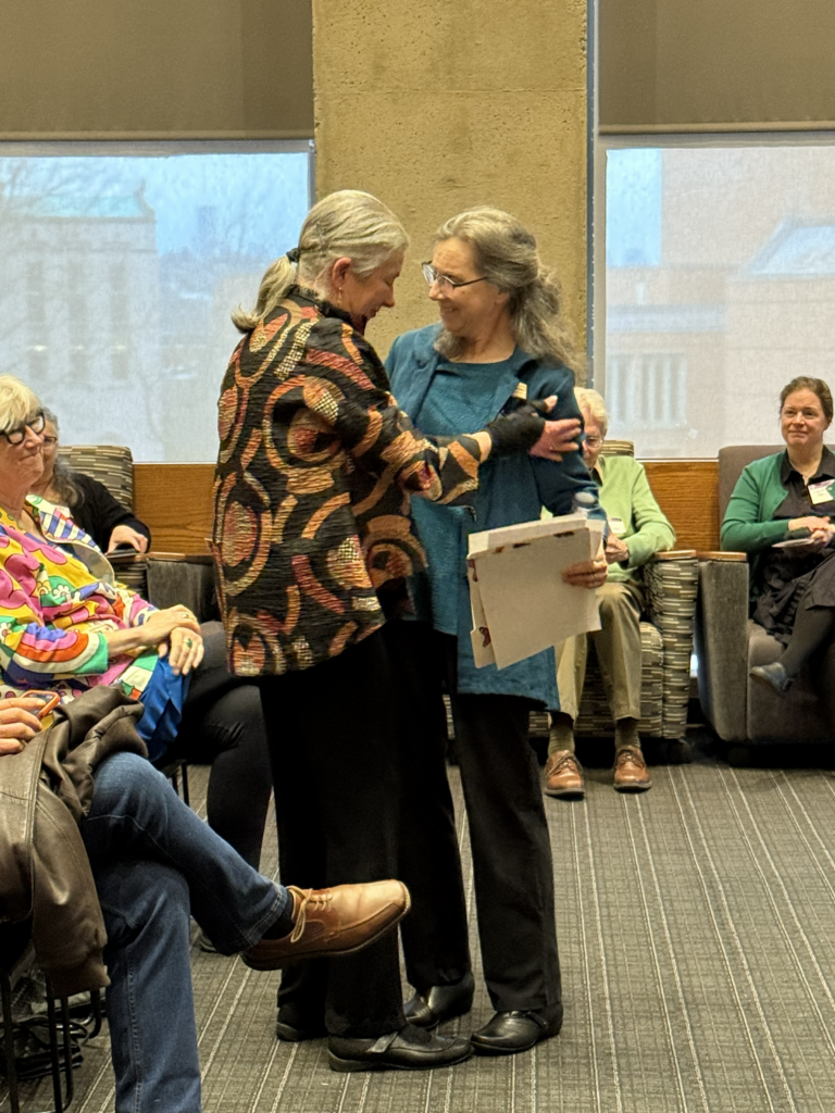Sandra embraces UW Libraries colleague Kathryn Leonard
