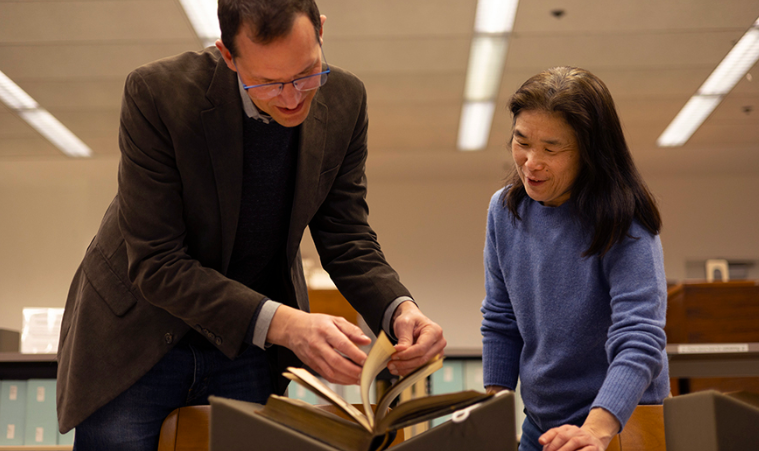 Scott Magelssen, executive director of the School of Drama, and Julie Tanaka, associate dean for distinctive collections at UW Libraries, look at the donated Shakespeare books in the Special Collections Reading Room. Photo by Juan Rodriguez.