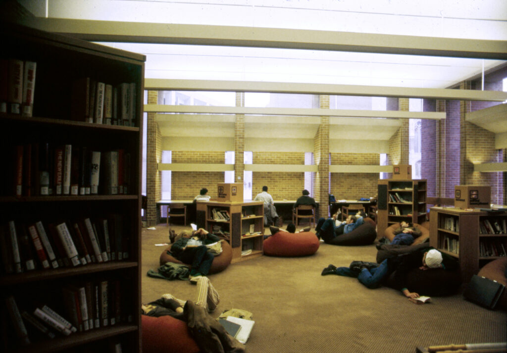 A photo of Odegaard Library in the 1970s. Students are studying and relaxing in bean bag chairs on the floor.