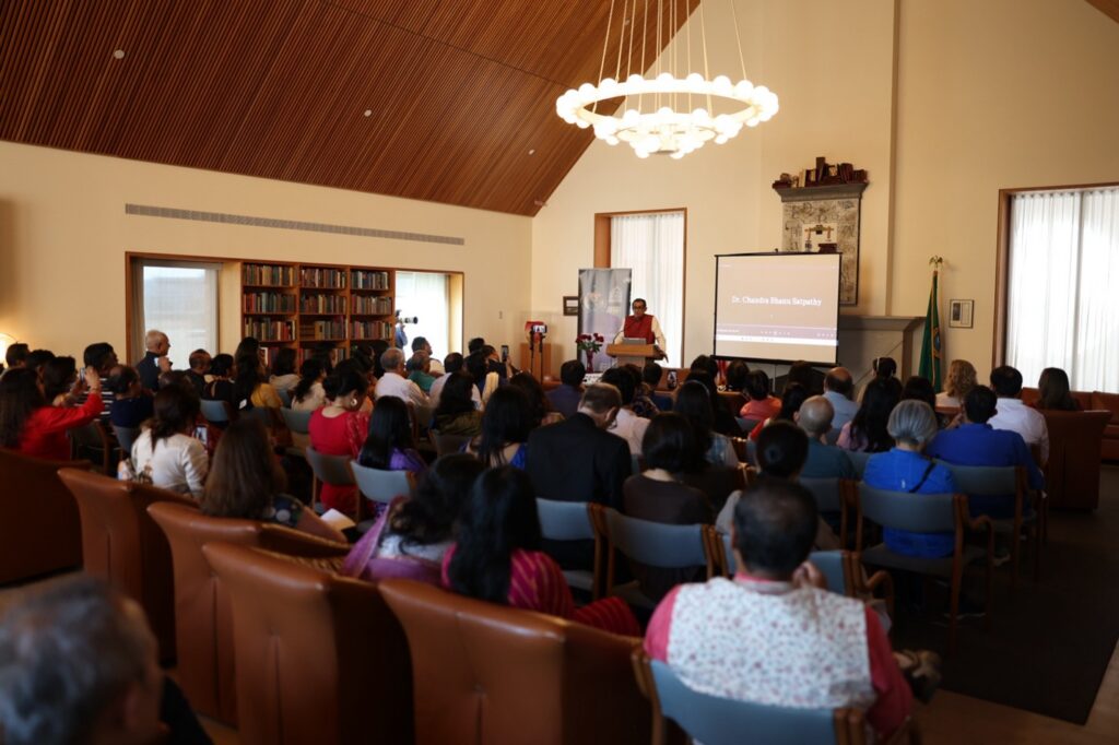 image: lecture room filled with guests