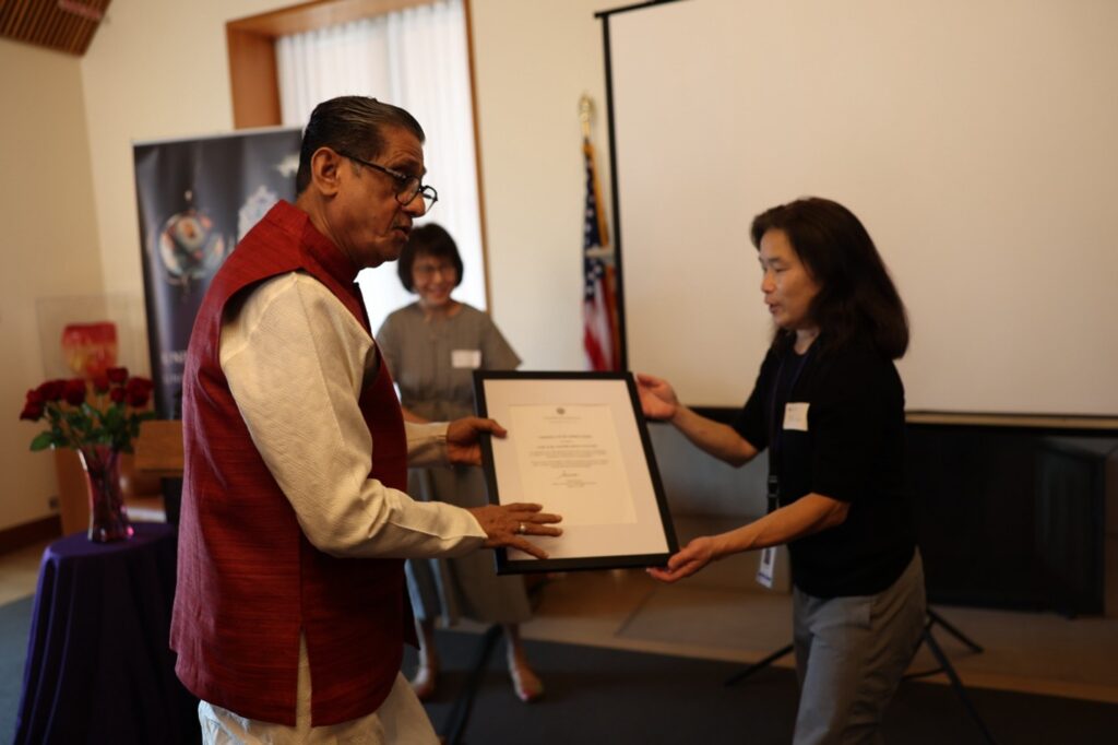Dr. Julie Tanaka presenting Certificate of appreciation from Dean Simon Neame of UW Libraries