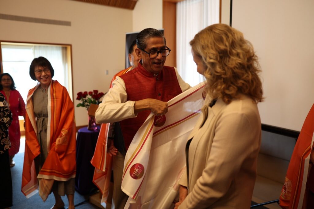 Photo: Guru Ji is draping ceremonial shawl on the shoulders of UW hosts