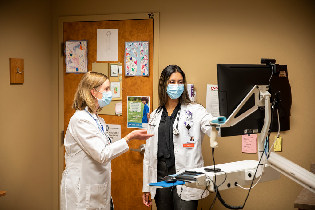 two clinicians looking at a screen